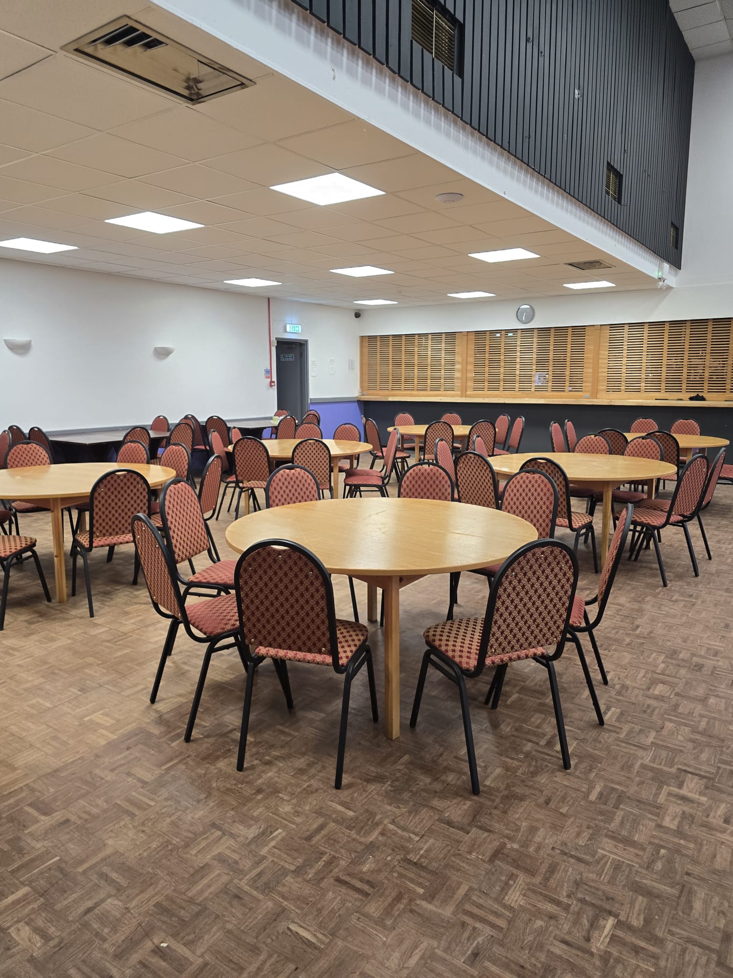 The function room set out cabaret style with round tables and chairs
